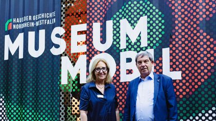 Vor dem MuseumMobil-Container stehen  Dr. Gabriele Uelsberg und Prof. a. D. Dr. Hans Walter Hütter 